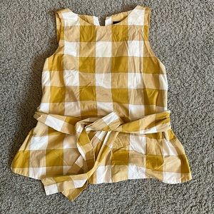 Tie front, sleeveless plaid top.